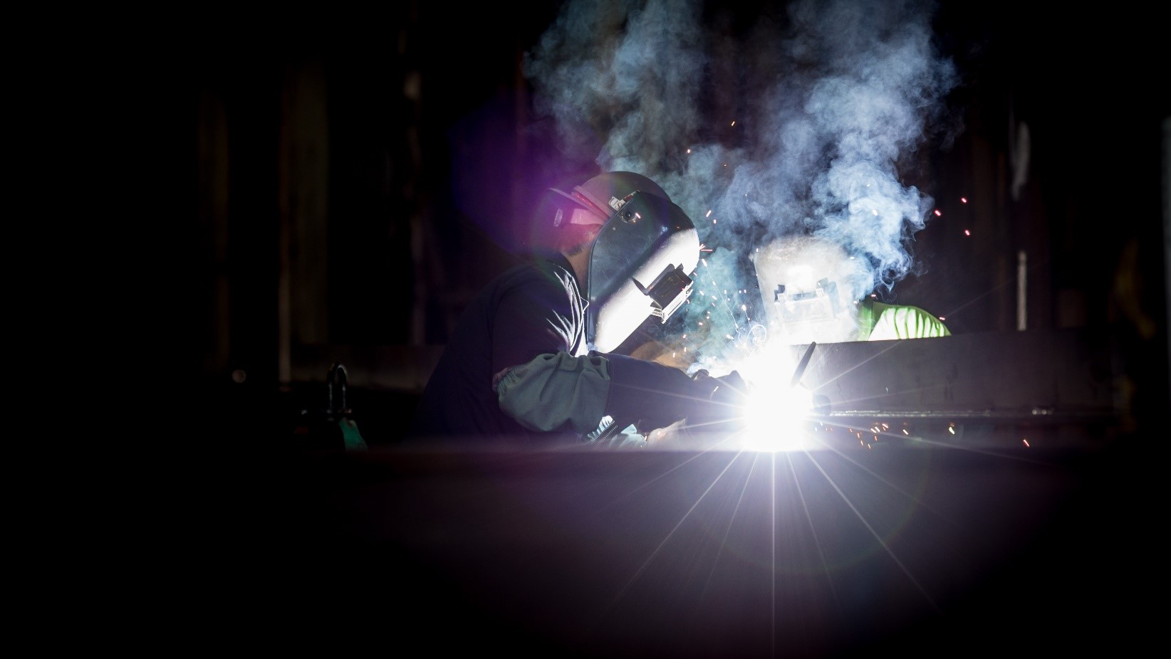 M1 Aluminum Mold Plate Being Welded| Howard Precision Metals Person welding M1 aluminum mold plate-Howard Precision Metals